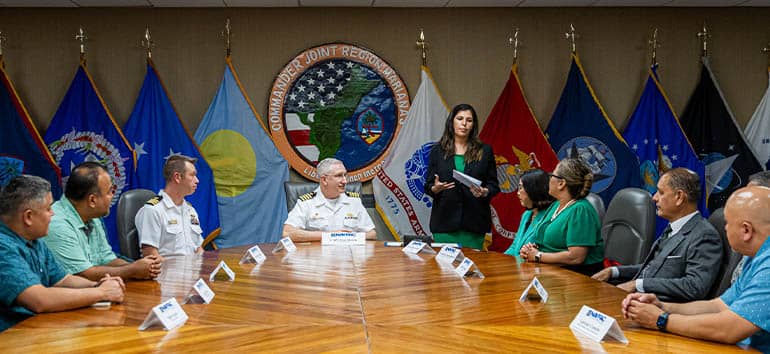 UOG President and Cap. Troy Brown sit at the head of table leading signing of Memorandum of Understanding with other members of UOG team sitting at their sides.