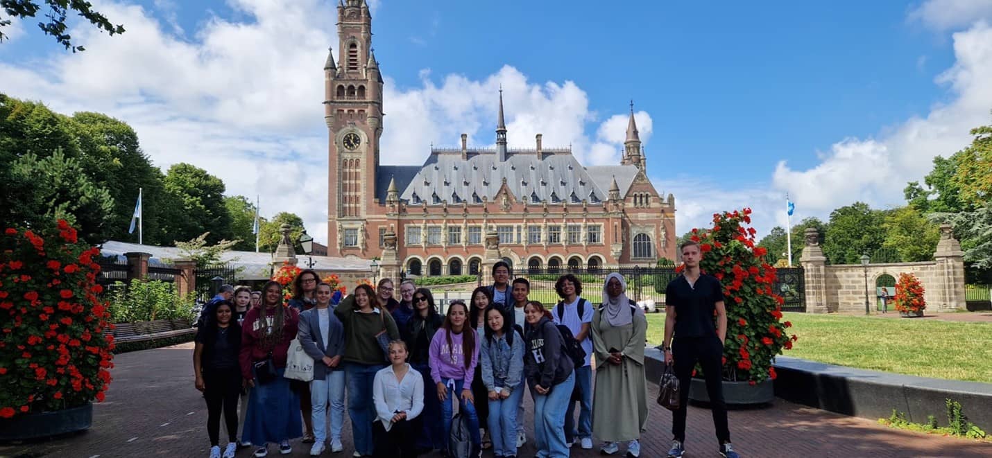 Tyra Delos Reyes, far left, joins her classmates for a photo in front of the International Court of Justice in The Hague. Photo courtesy of Tyra Delos Reyes