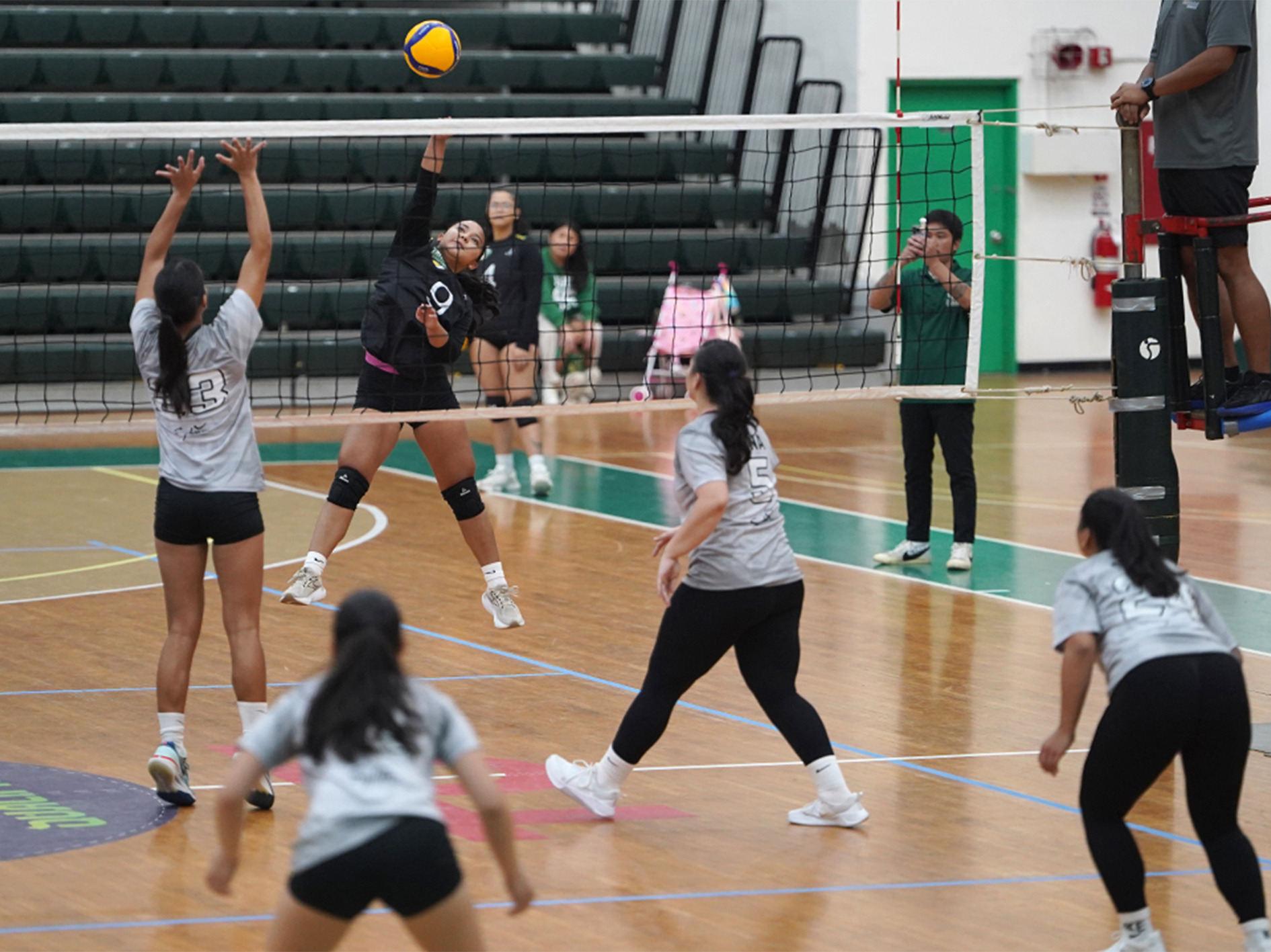 women teams play volleyball at UOG fieldhouse for Lady Triton Volleyball League