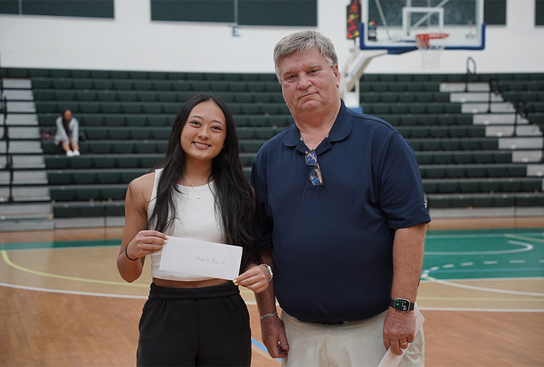  Marie Duenas poses for photo with award and coach