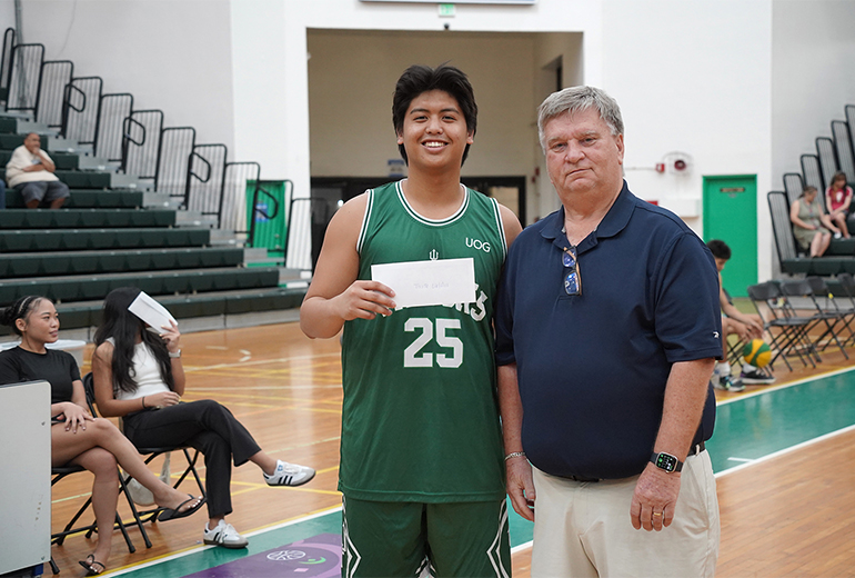 Tristan Valdes poses for photo with award and coach
