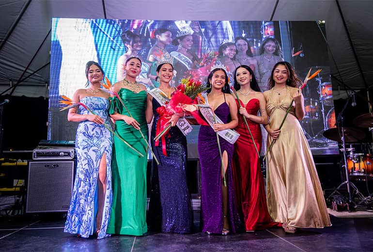 Miss UOG contestants stand in a line and pose for photo on stage after awarding